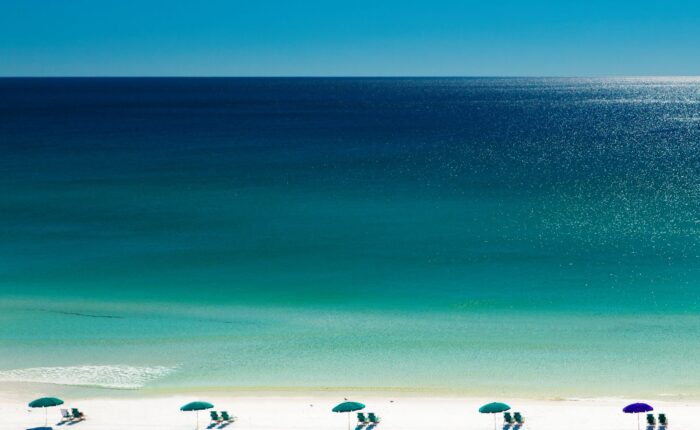 Beach umbrellas and deck chairs on beach, Destin, Florida, USA