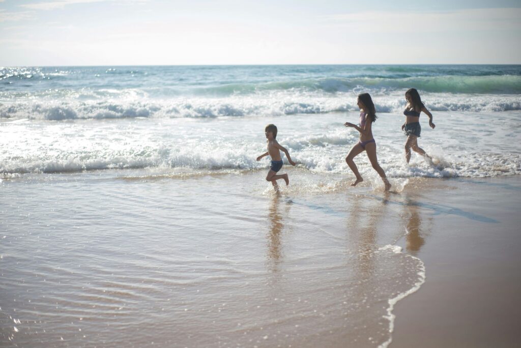 kids running on the beach