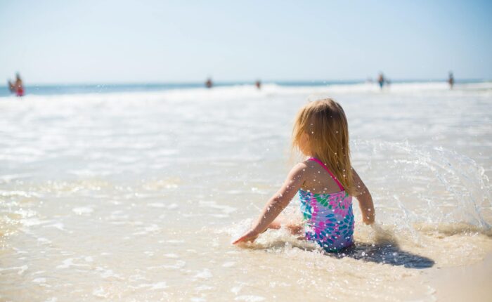 girl sitting on the shore