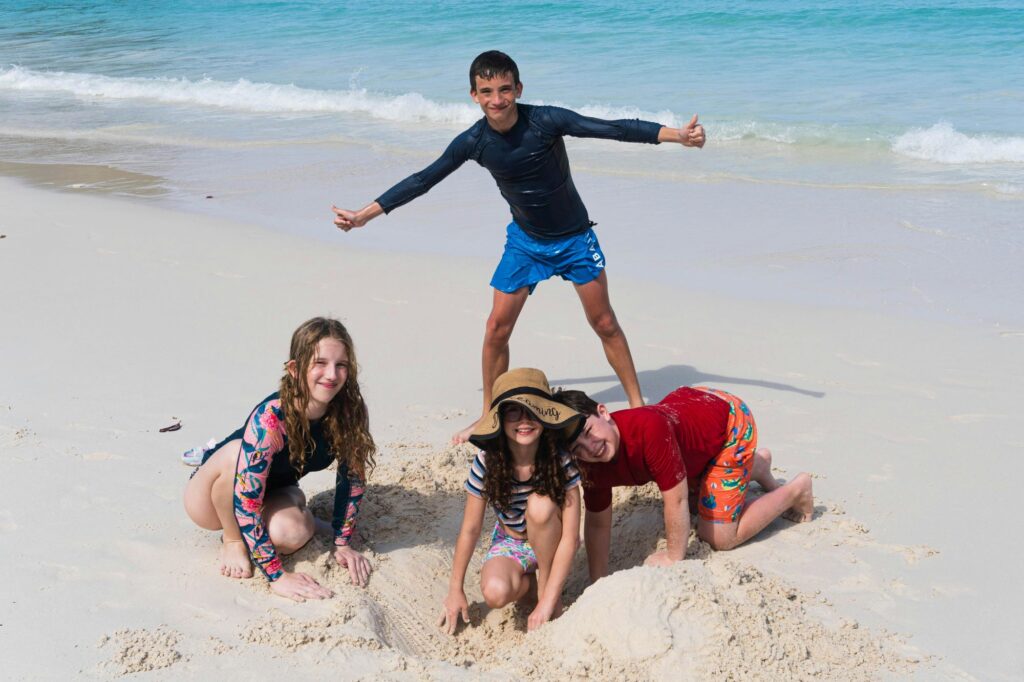 a group of kids on a beach