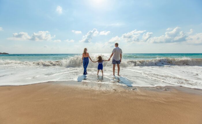 a family of three at the beach